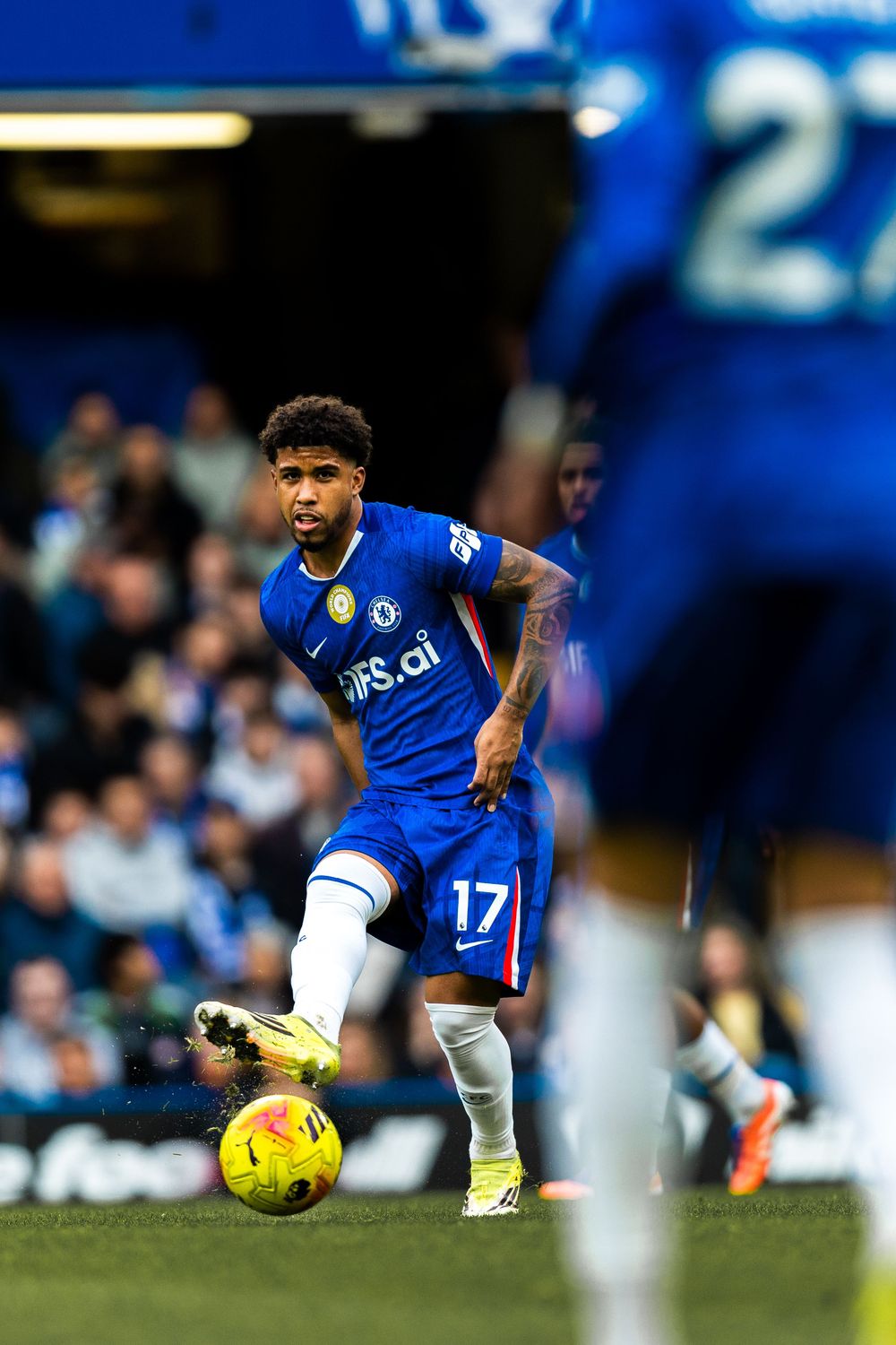 Leicester City player in blue jersey makes a skilled move with the ball during Premier League match.