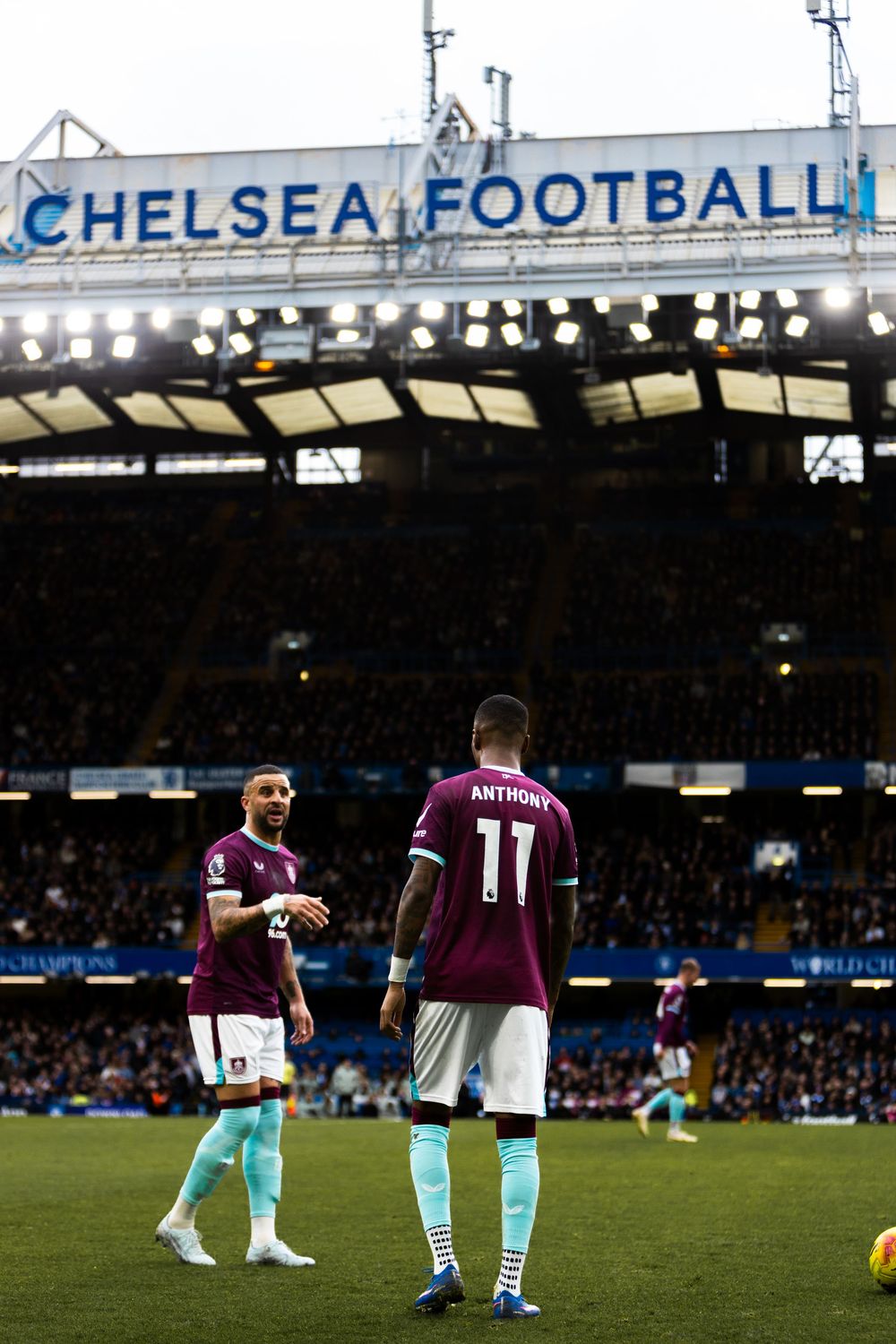 Soccer players kneel on the field before a match at Chelsea Football Club's stadium during a pre-game ceremony.