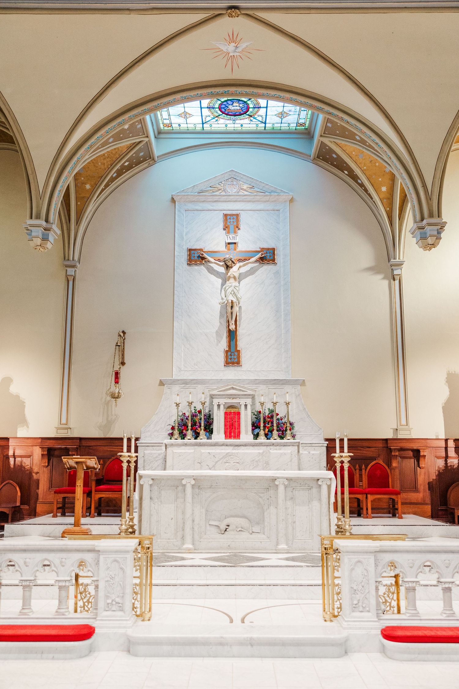 Four panoramic views of a white marble church altar with arched ceilings and crucifixes in traditional Catholic style.