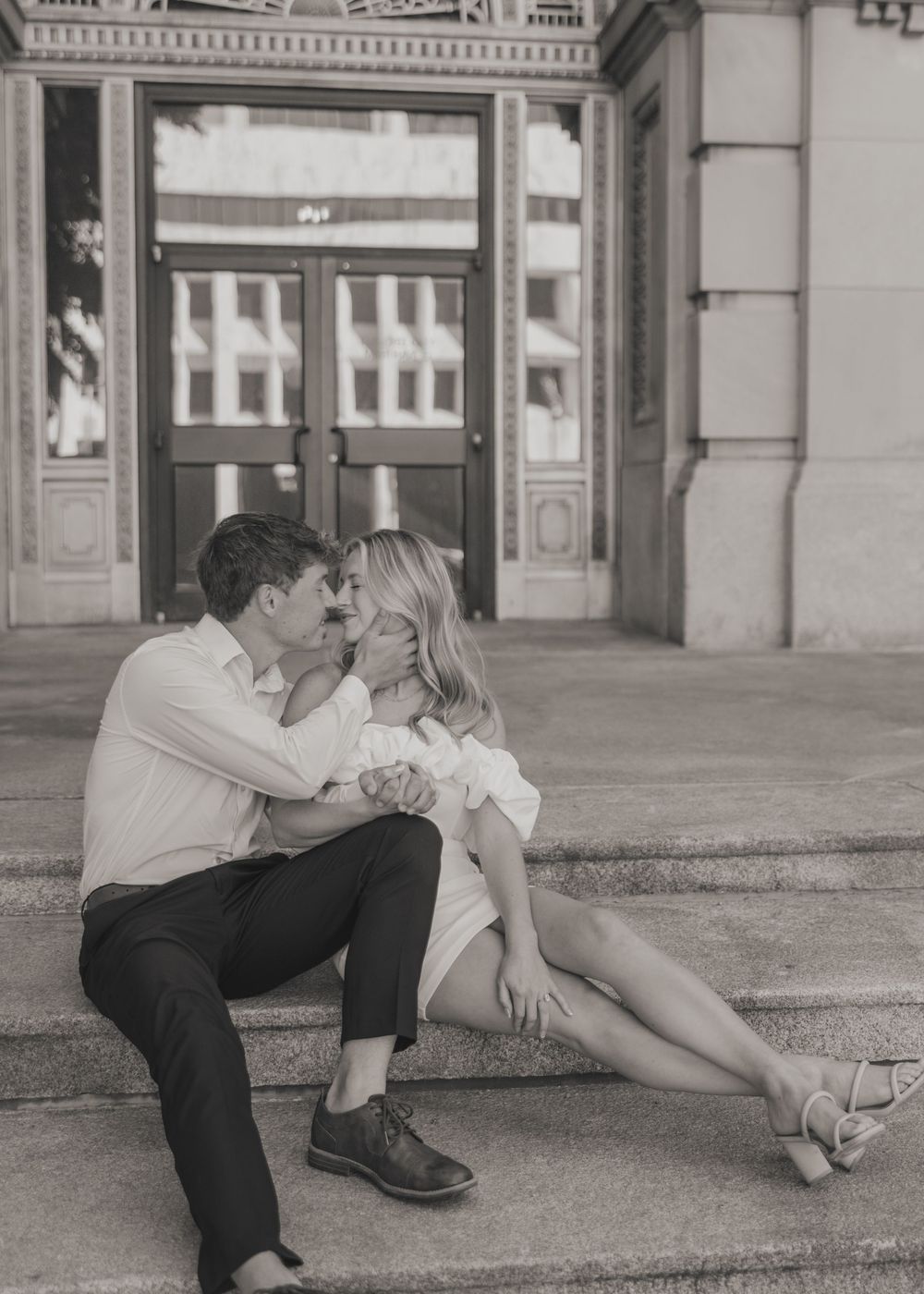 A romantic black and white photo sequence shows a couple in a passionate dip pose against an architectural backdrop.