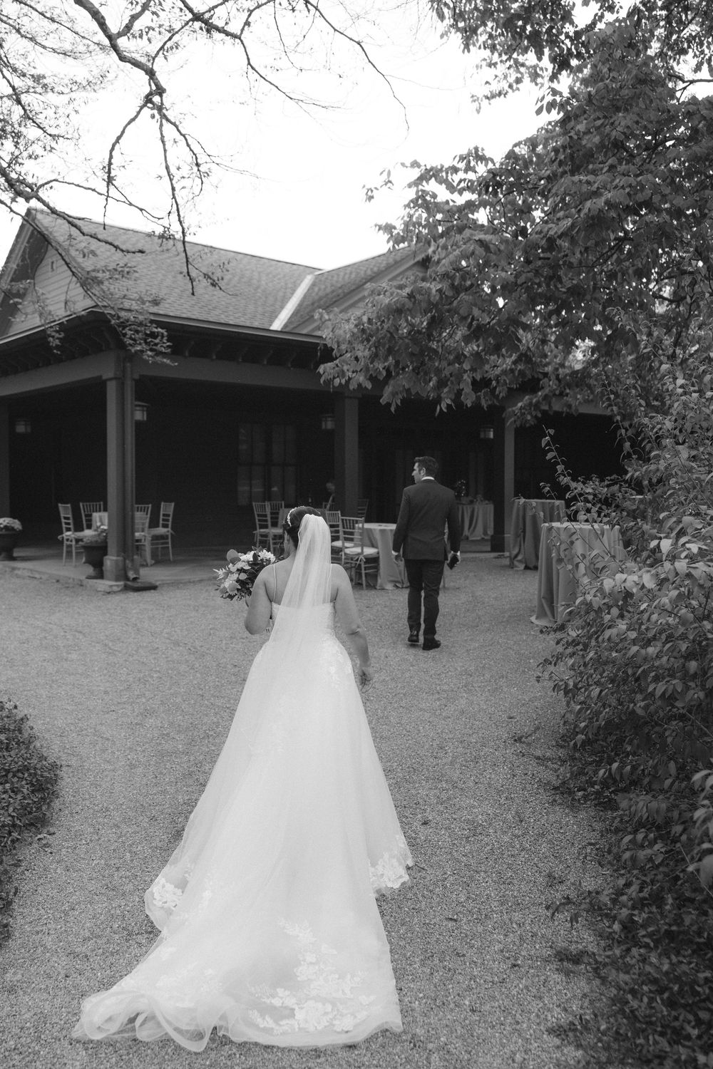 A black and white wedding photo sequence showing a couple walking through a traditional Asian temple courtyard.