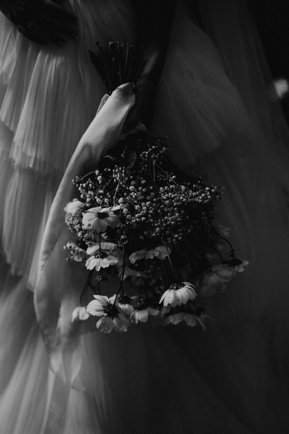Close-up details of a wedding bouquet with delicate flowers in black and white.