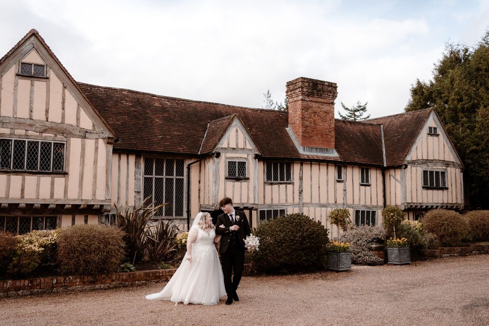 Tudor-style wedding venue exterior with classic architecture and landscaping.