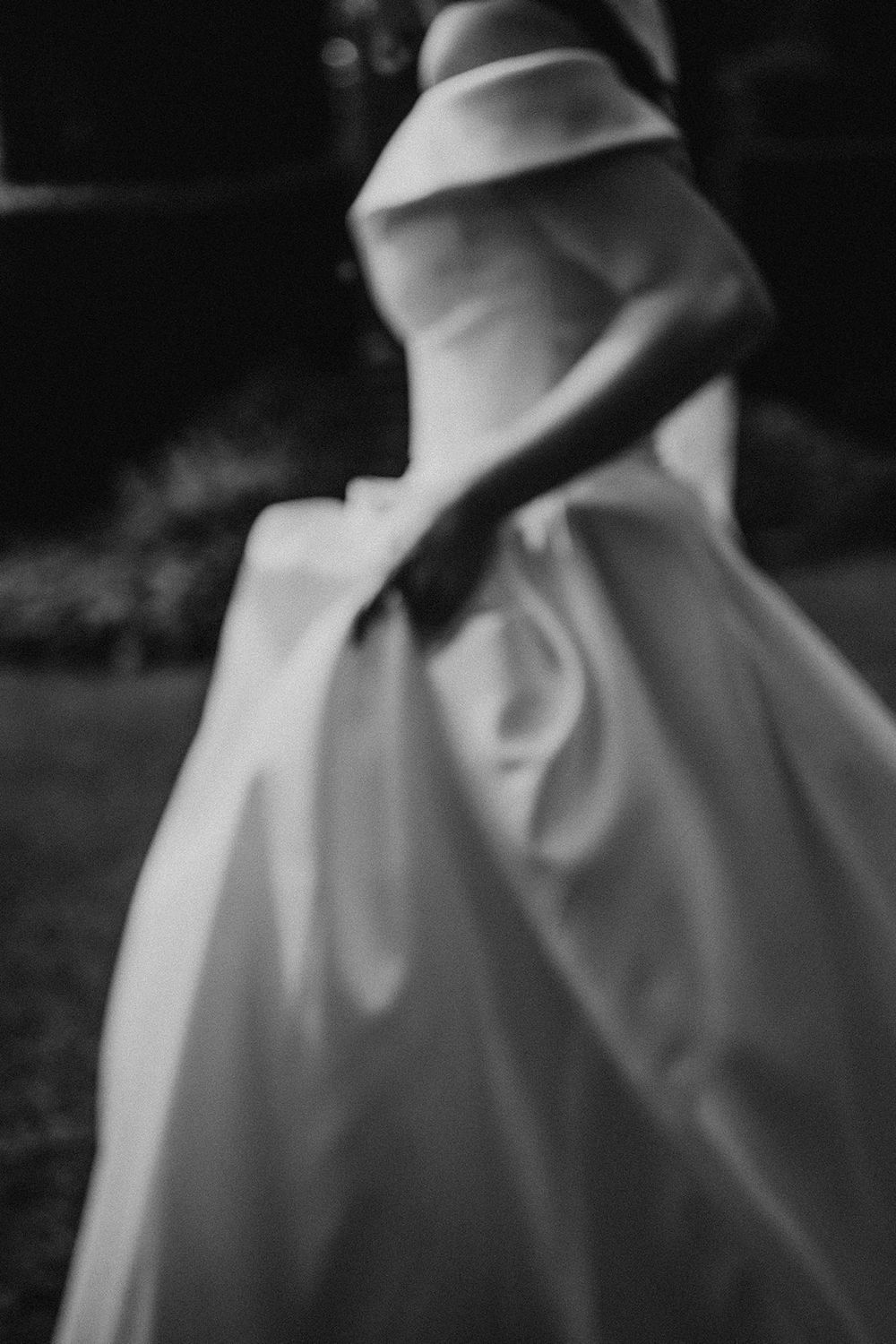 Abstract black and white close-up of flowing white wedding dress fabric.