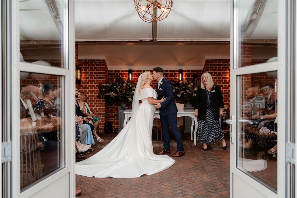 Wedding reception venue interior with glass walls and elegant lighting.