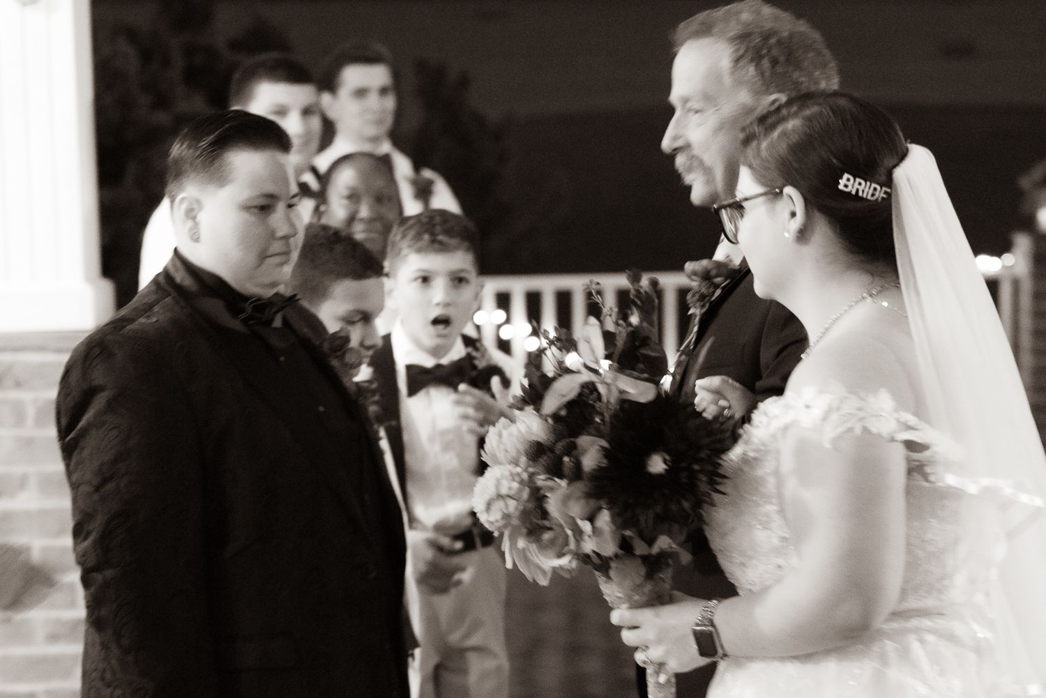 A black and white photo collage showing candid moments from a wedding celebration with dancing and toasting.