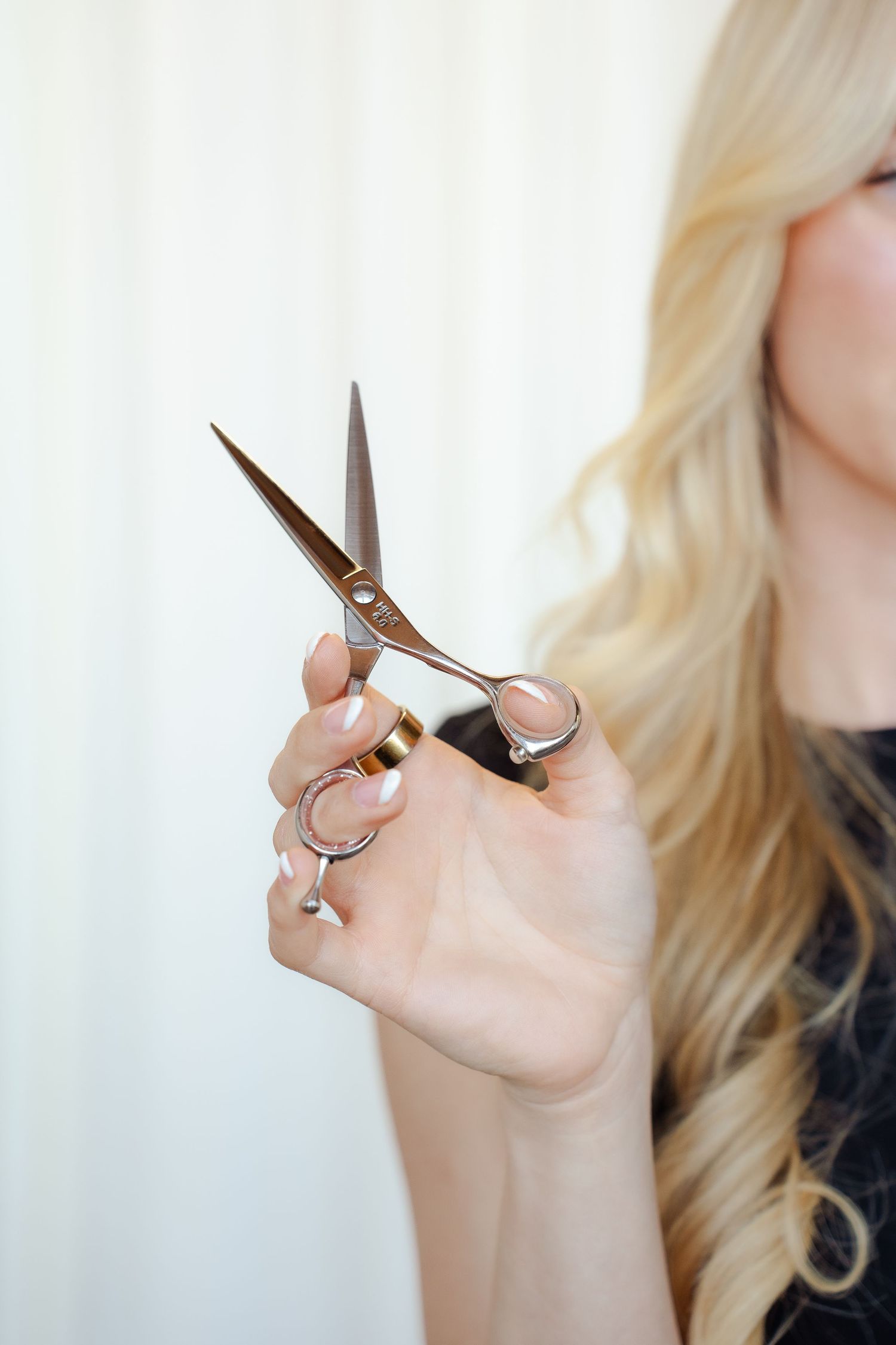 Close-up shots of a brown pinstripe outfit with buttons and details against a white curtain backdrop.