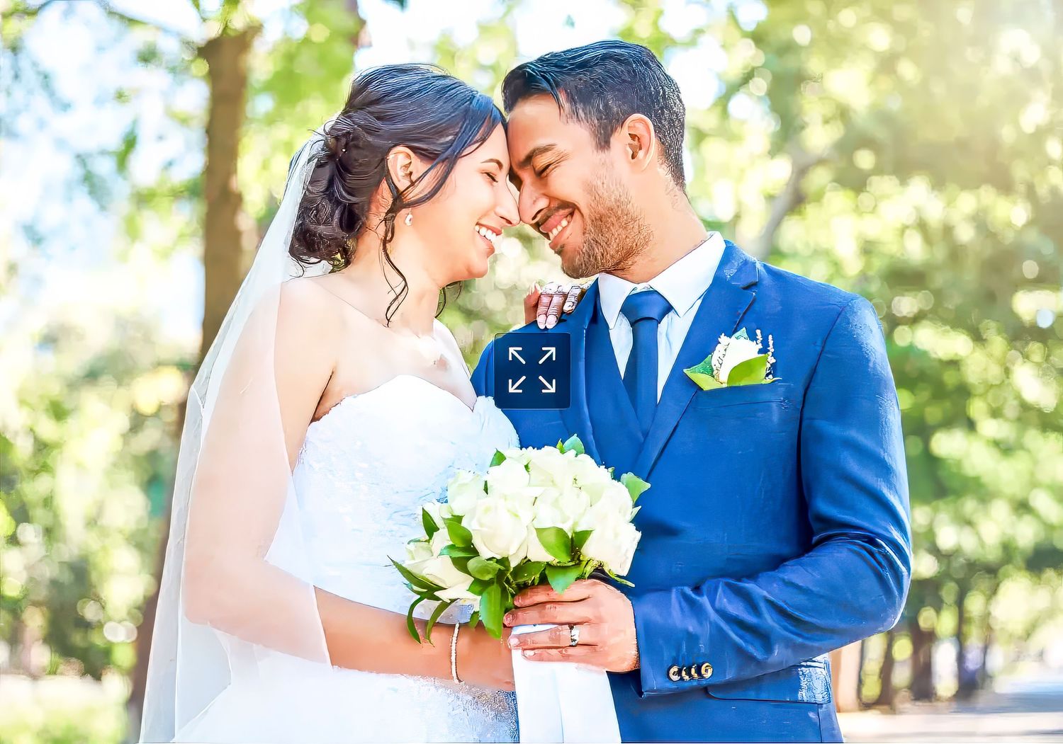Romantic wedding couple embraces in a sun-drenched garden setting with soft bokeh lighting effects in background.