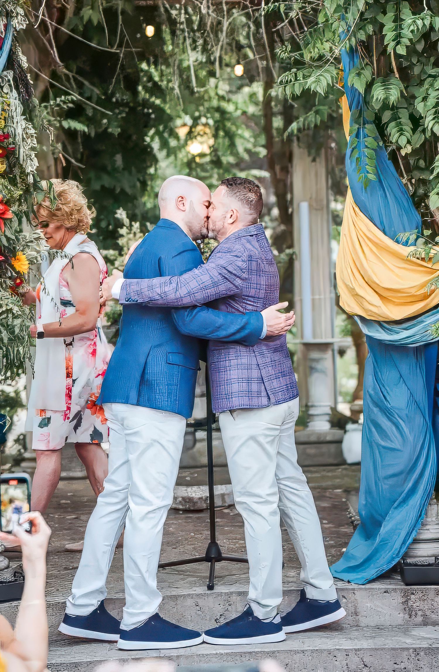 A series of progressive photos showing a couple dancing together in a garden setting with hammocks in the background.
