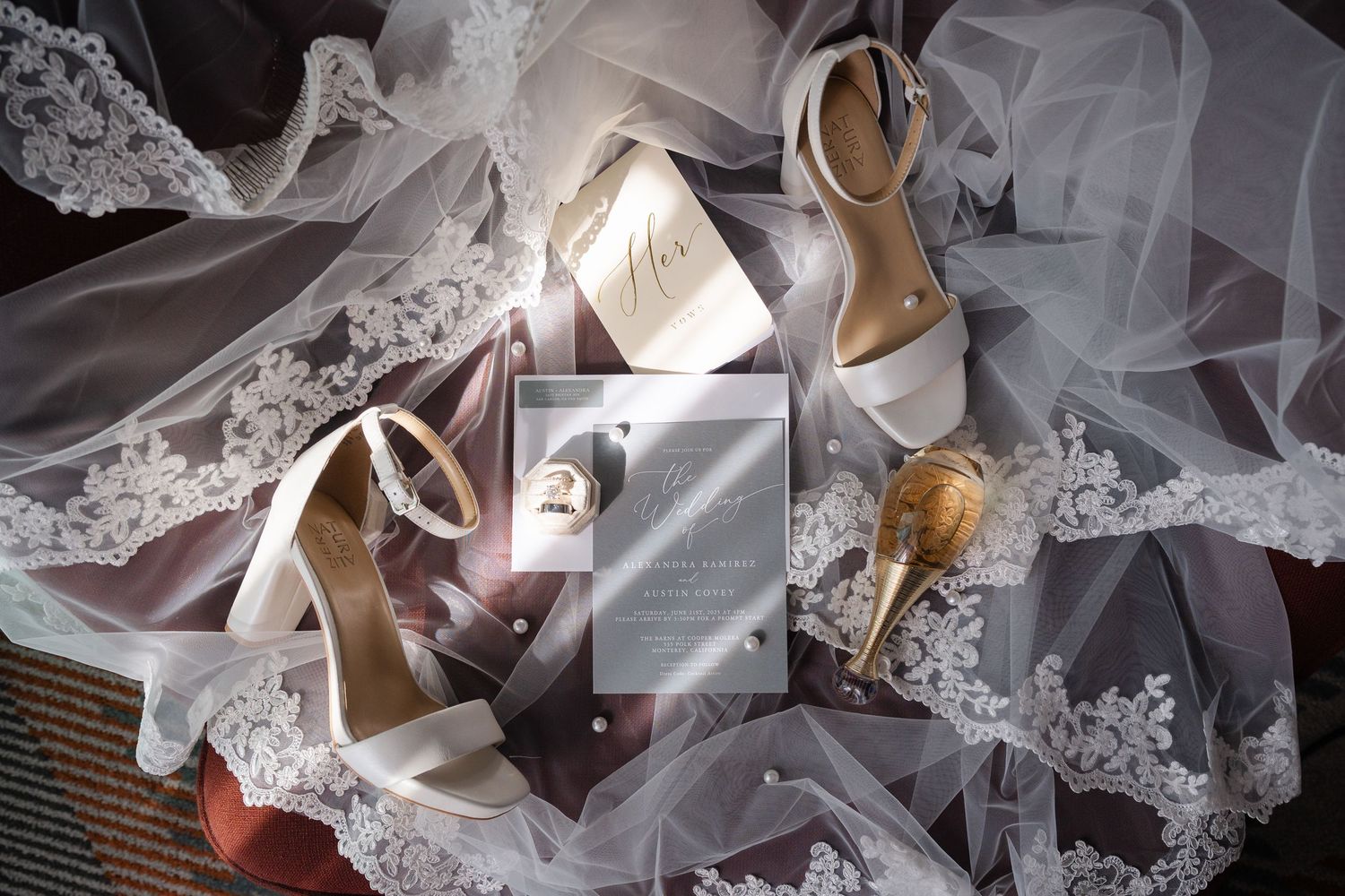 Delicate white lace fabric and gold high heel shoes arranged in an artistic bridal fashion composition.
