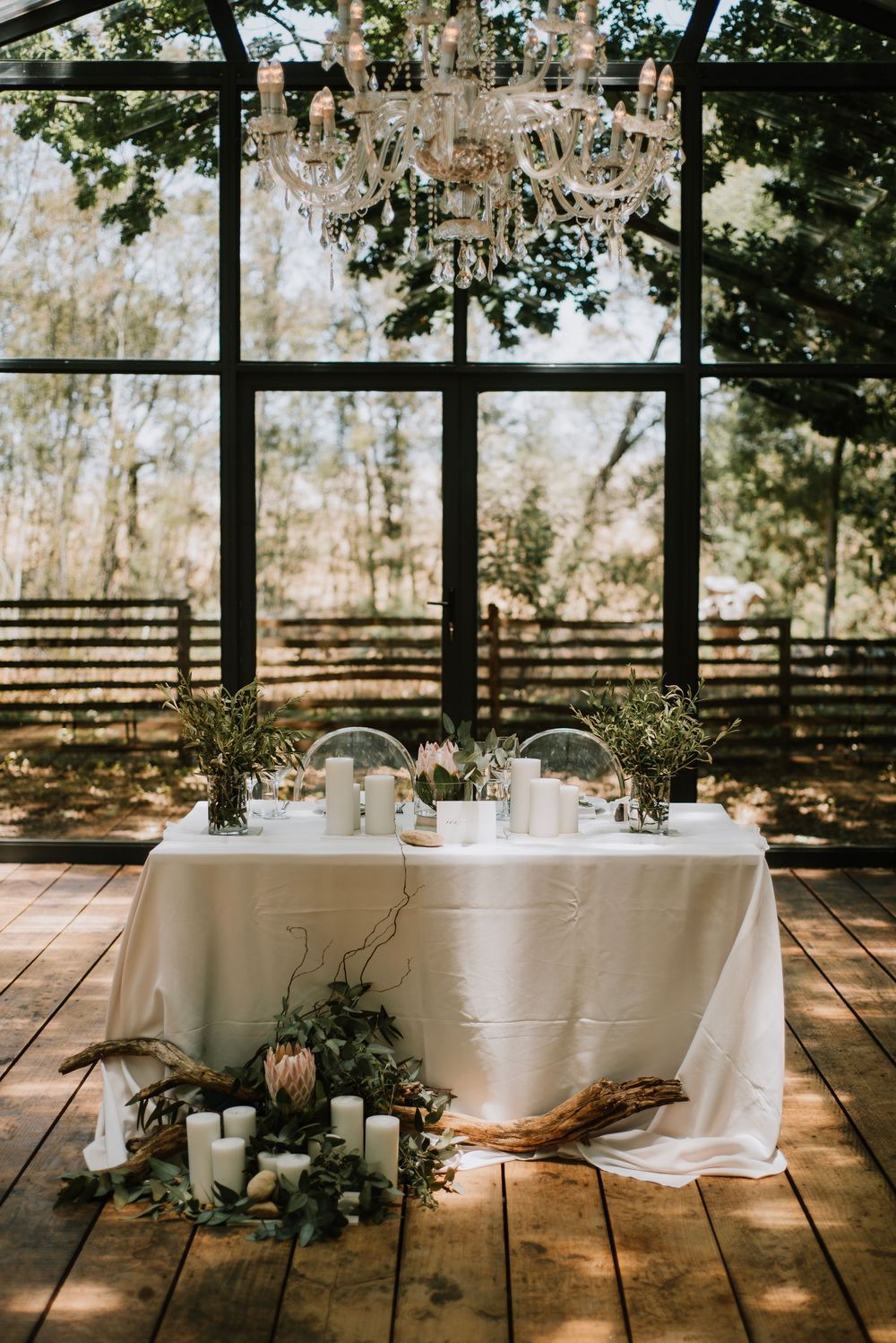 Elegant minimalist wedding decor at Die Woud Wedding Venue featuring king proteas and olive leaves in a refined, natural styling
