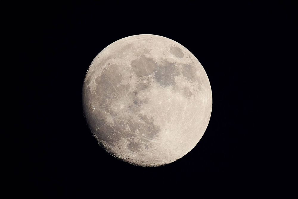 A detailed photograph of the full moon showing its craters and surface features against a dark sky.