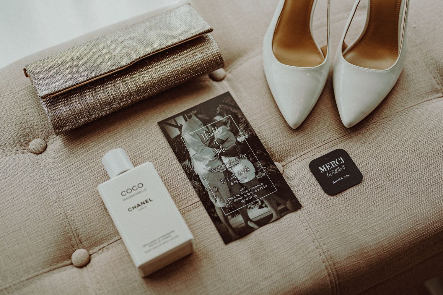 Wedding details flatlay with white shoes, perfume bottle, and vintage photograph.