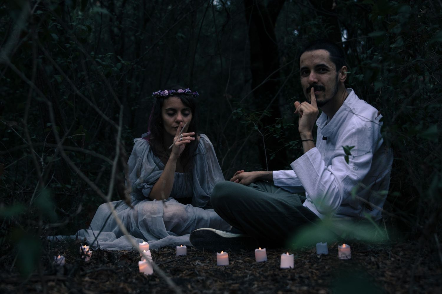 Intimate forest photography session with candlelit ambiance and natural surroundings.