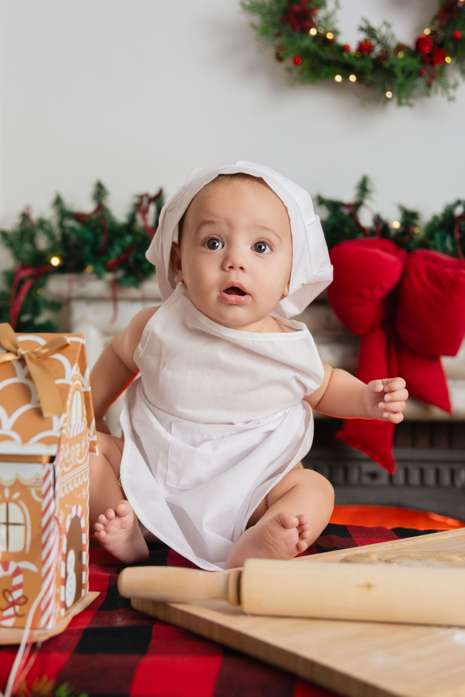 A festive Christmas scene with a rolling pin and holiday decorations in the background.