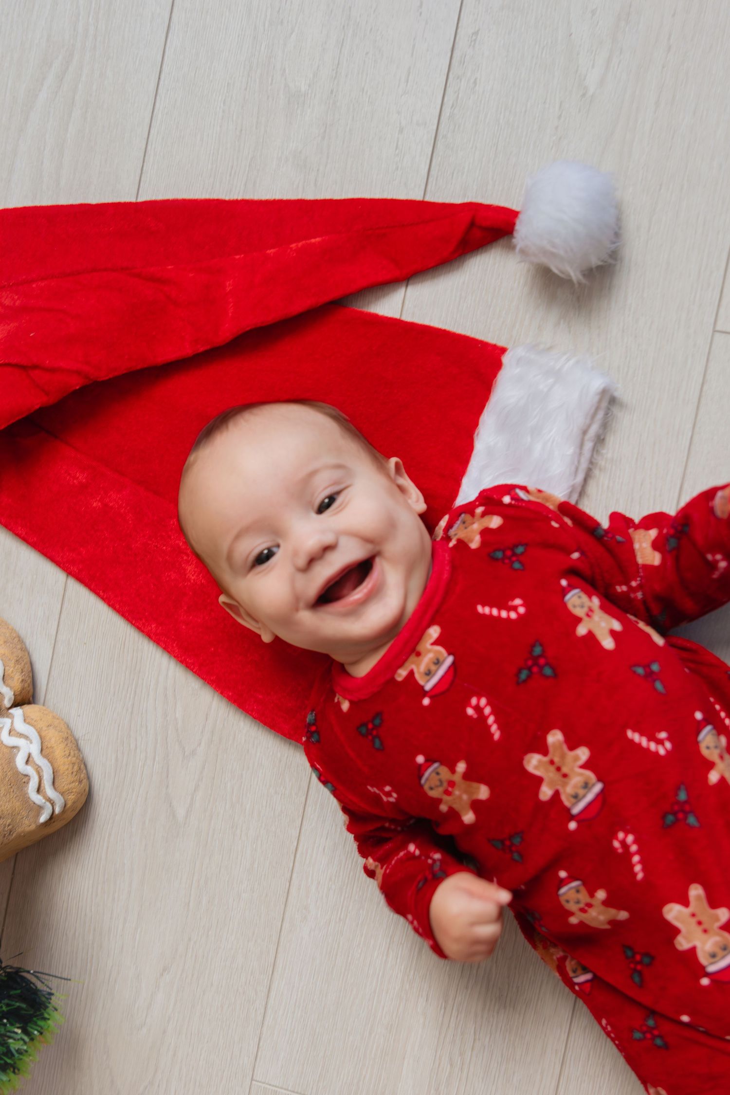 A joyful holiday scene with red gingerbread pajamas and Christmas decor.