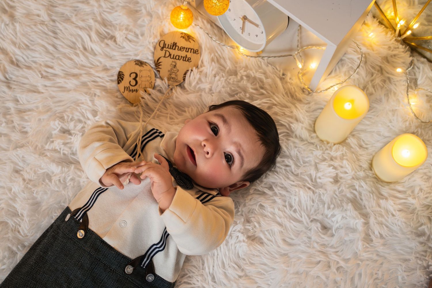 A cozy winter scene with twinkling lights and plush white fur blankets creating a warm, festive atmosphere.