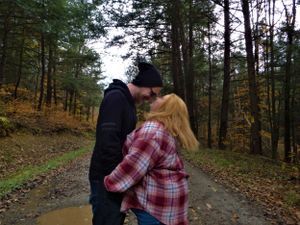 A romantic autumn walk through a wooded trail with fallen leaves covering the path.