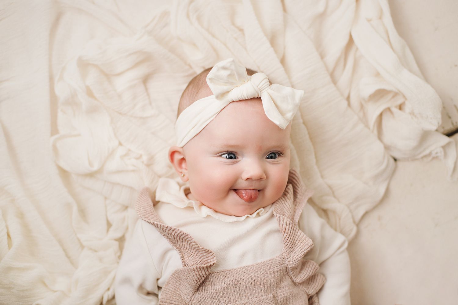 Series of delicate portraits showing sweet expressions against soft white textured backgrounds.