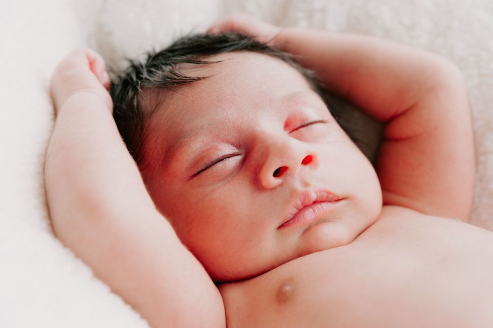 A peaceful infant sleeps soundly while stretched out with arms raised above their head.
Altona Family Photographer Melbourne