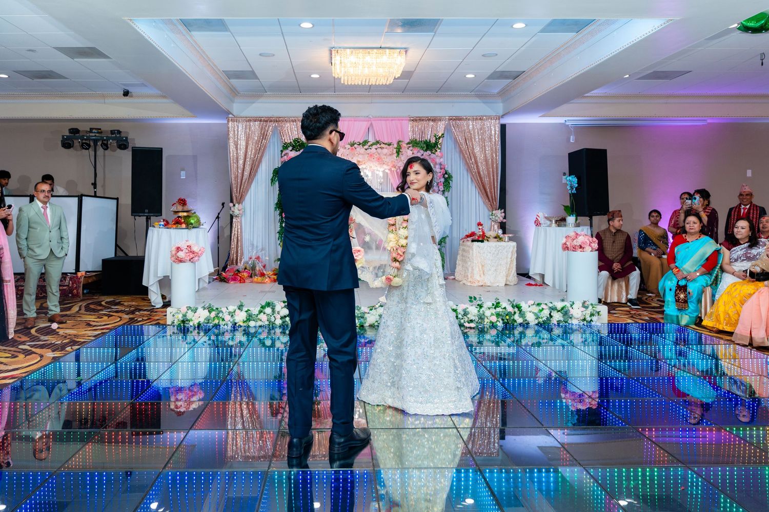 Wedding couple performs choreographed dance moves on a glowing LED floor at their reception.
