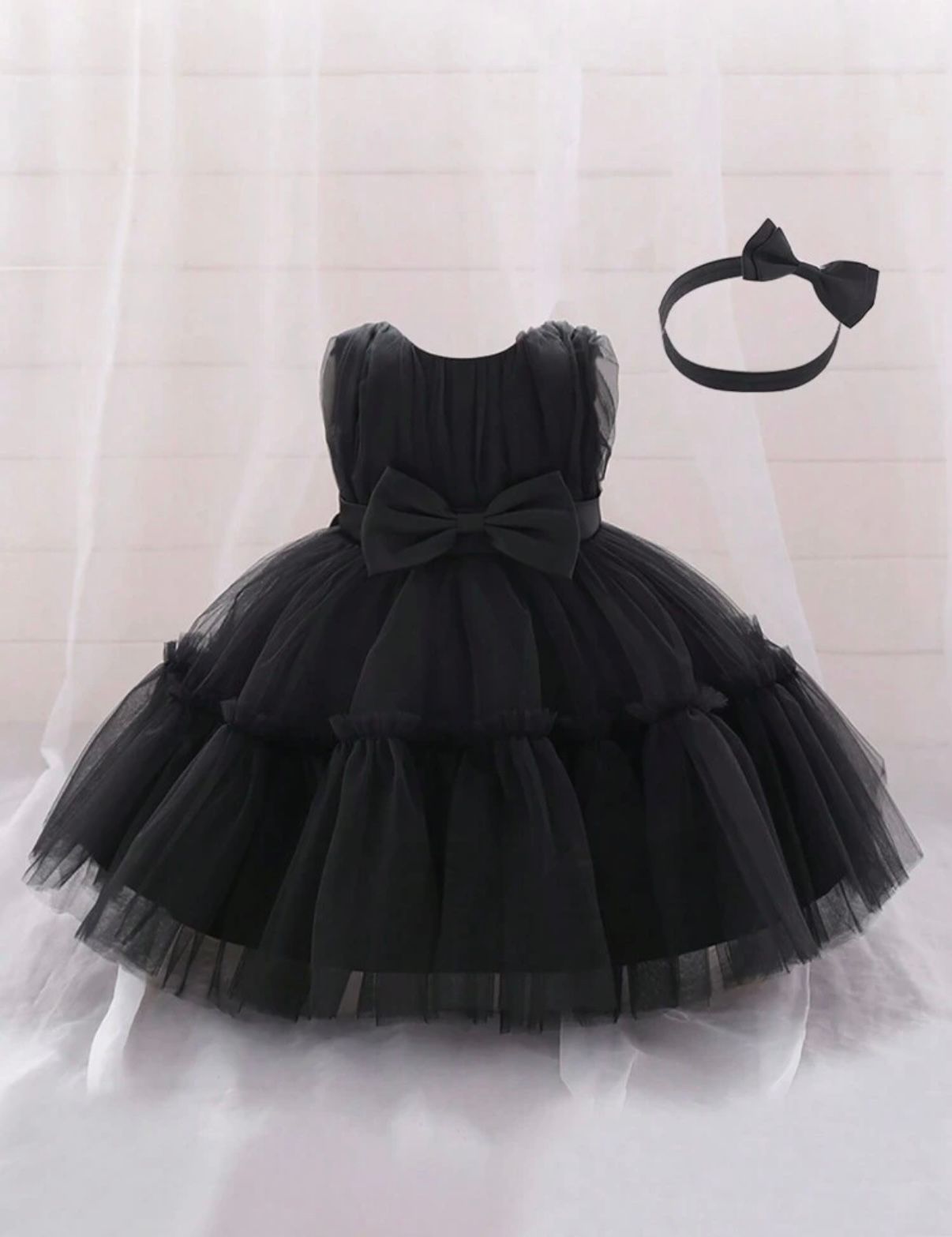 Black tulle tutu skirt with bow detail photographed from different angles.