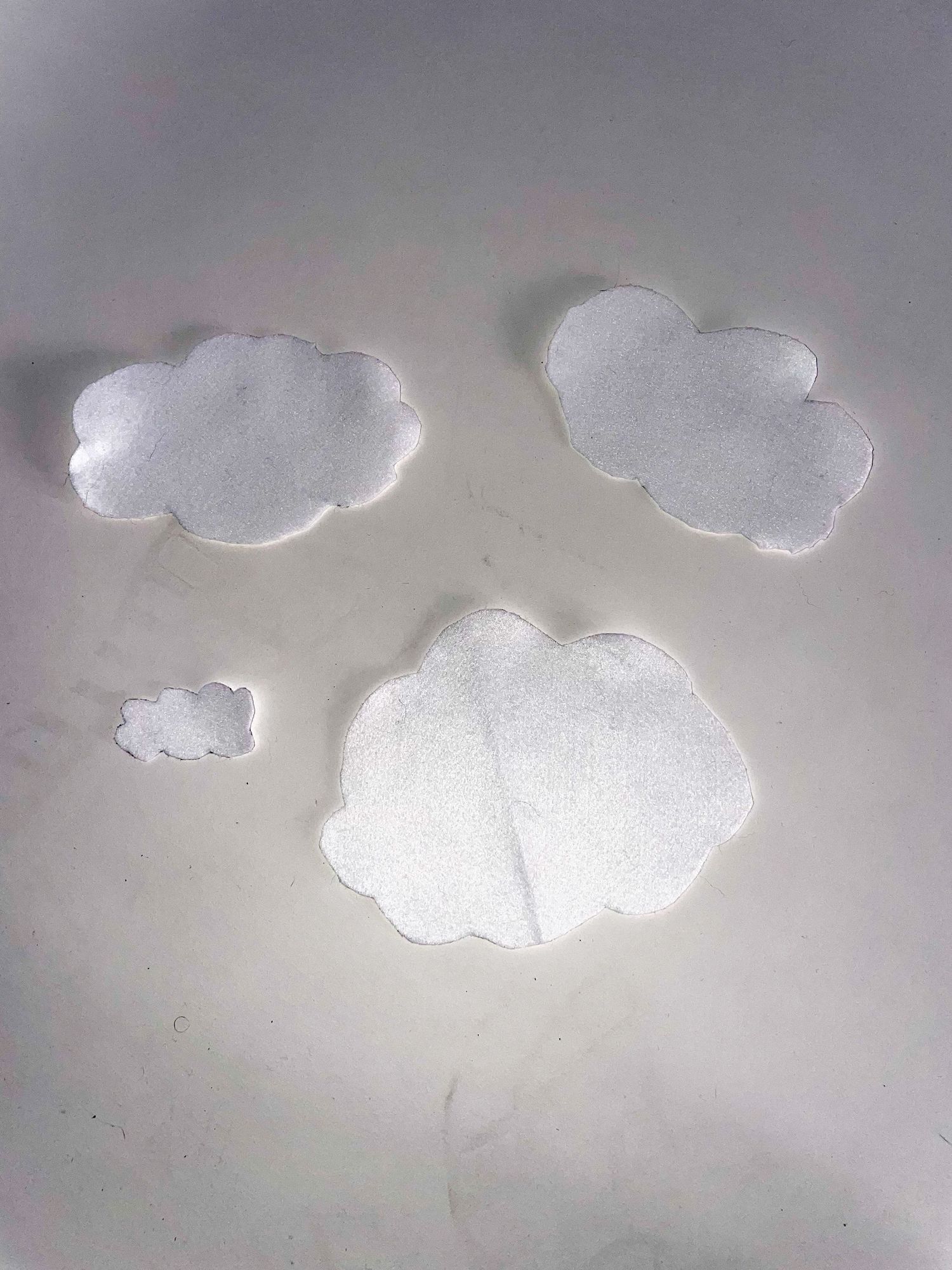 Soft white cloud formations against a muted gray background.