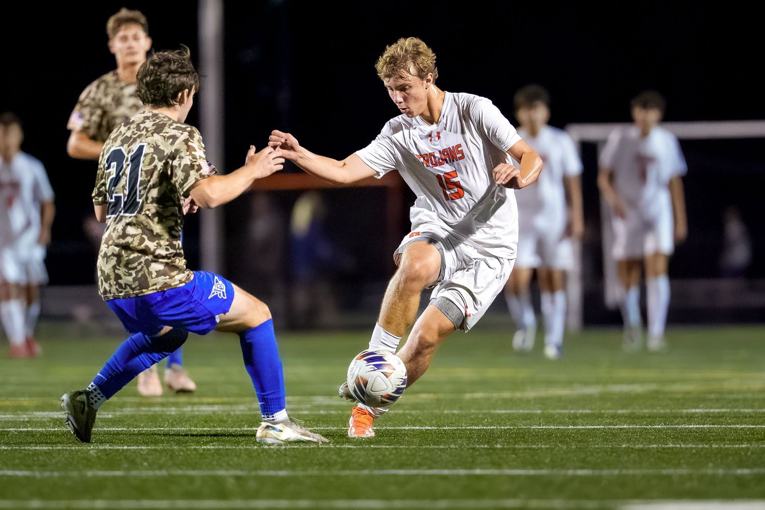 Hershey Trojans boys soccer game day action dribbling at night, by Deanna Fox, SportsFox Photography, Hershey PA