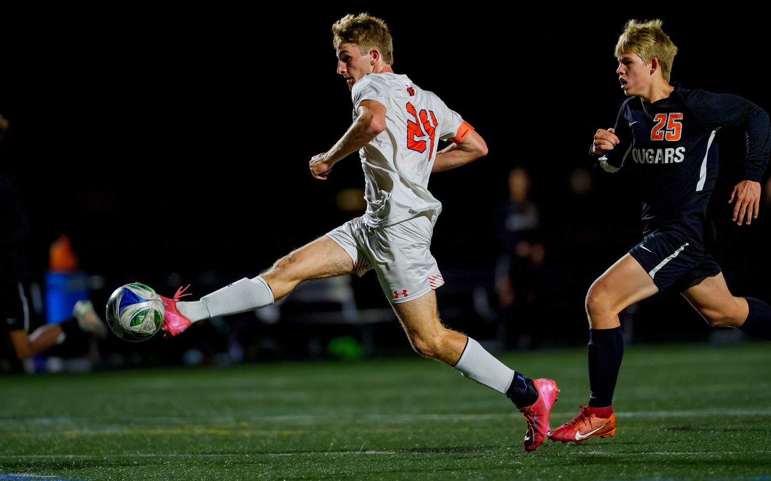 Hershey Trojans boys soccer player shooting game day action at night, by Deanna Fox, SportsFox Photography, Hershey PA