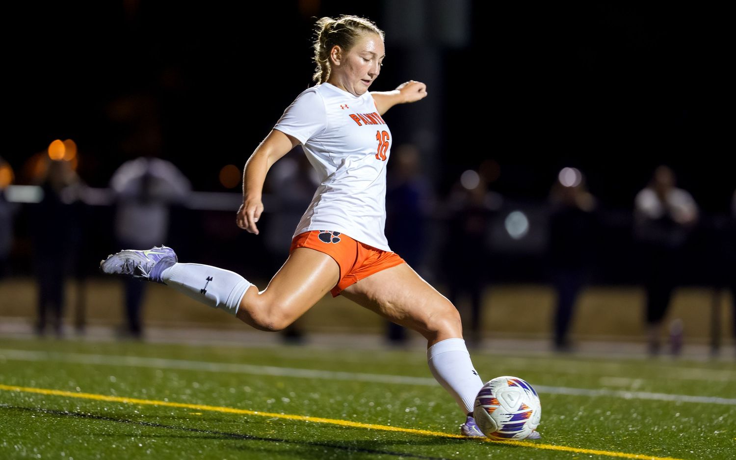 Palmyra Cougars girls soccer player kicking game day action at night, by Deanna Fox, SportsFox Photography, Hershey PA