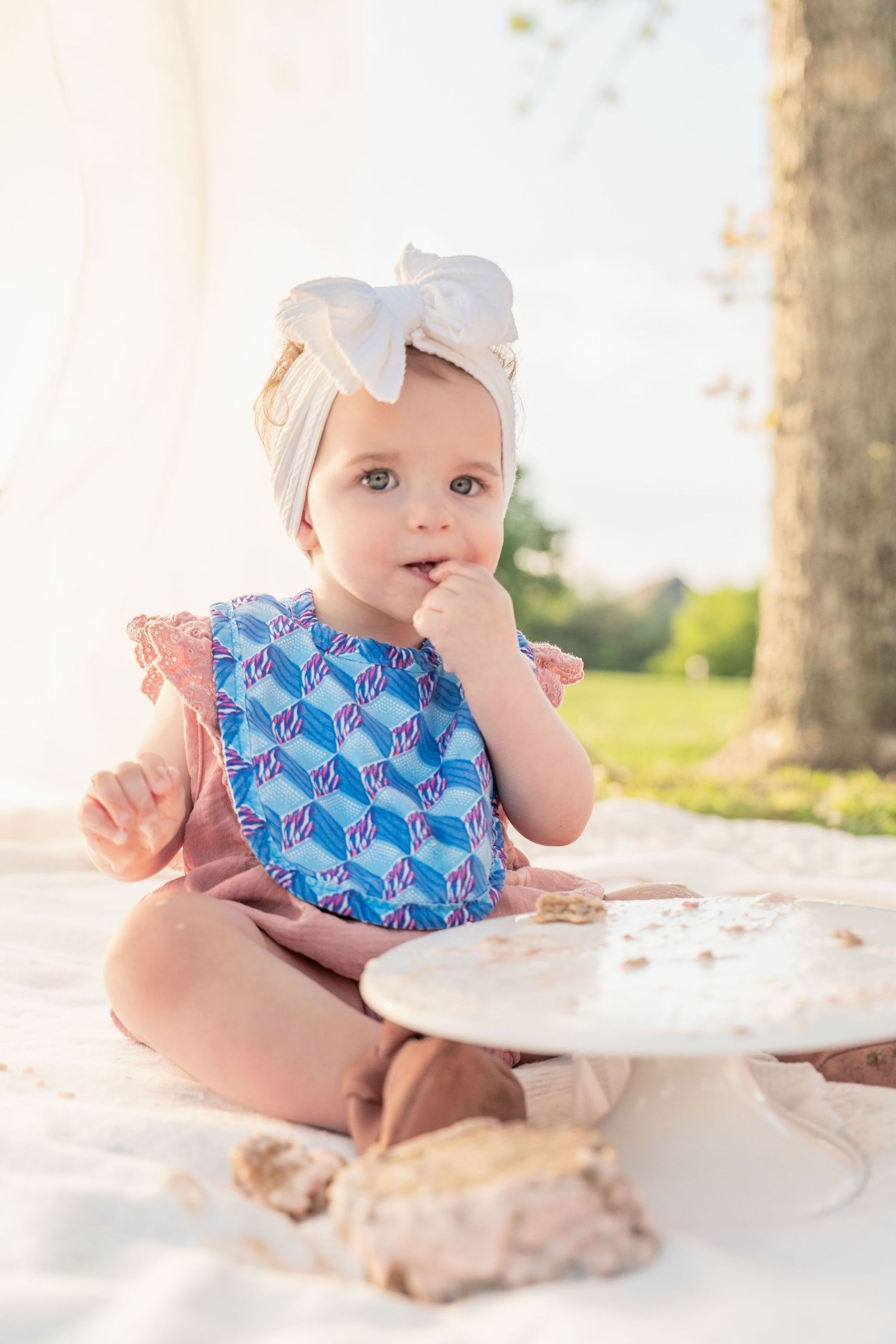 toddler girl cake smash one 1 year milestone outdoor photography, pink cake, conroe photographer