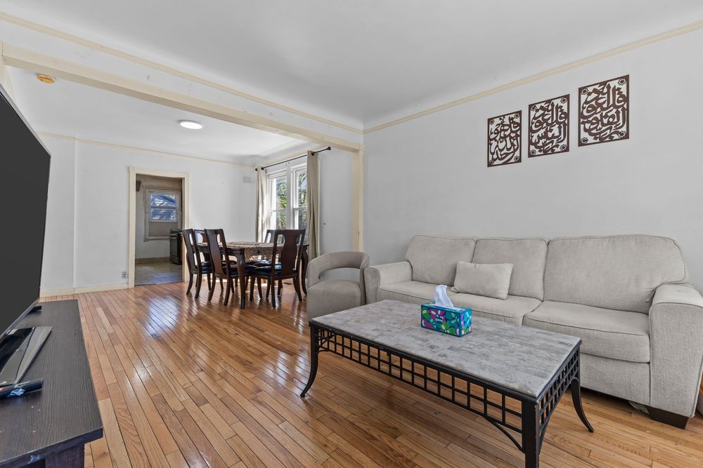 Living room with bay windows and hardwood floors in Dearborn Michigan bungalow
