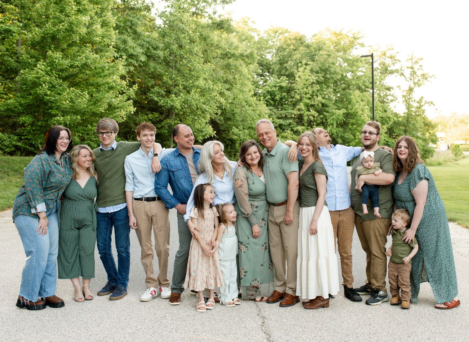 Multi-generational family laughing together during outdoor photos in O’Fallon Missouri