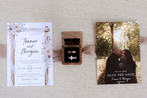 Wedding invitation suite with floral design, ring box, and save the date card for Tanner and Morgan.