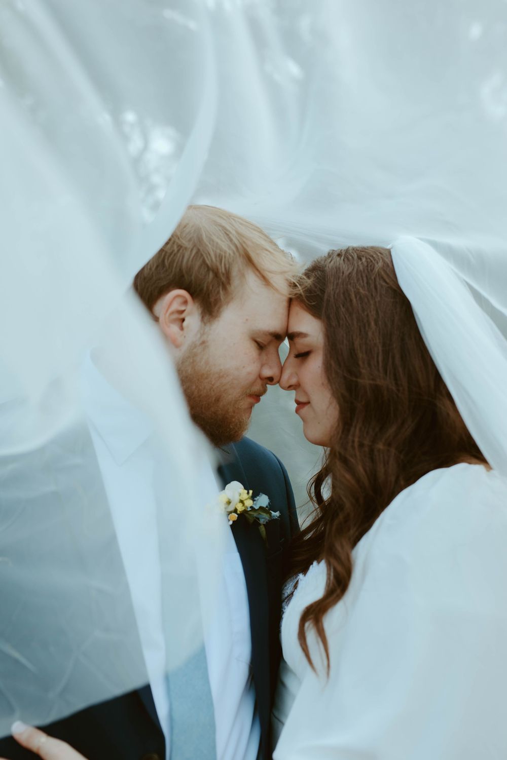 Romantic and intimate bridal portrait of a couple underneath the veil at a Wimberley, TX wedding photoshoot.