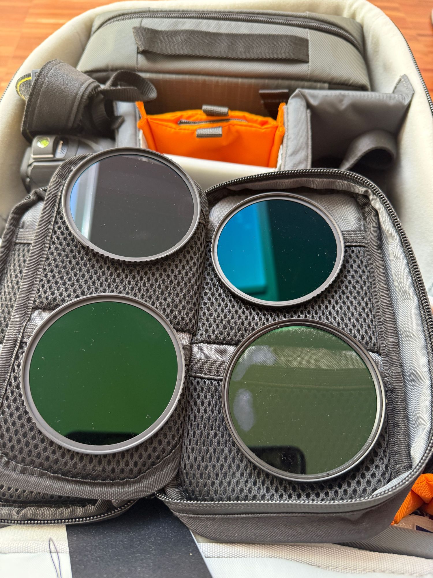 Camera bag with four circular filters including green and blue infrared filters.