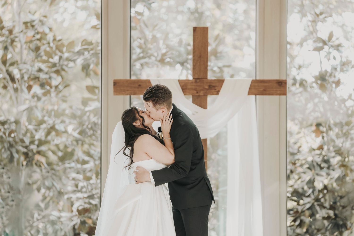 Bride and groom sharing their first kiss as husband and wife