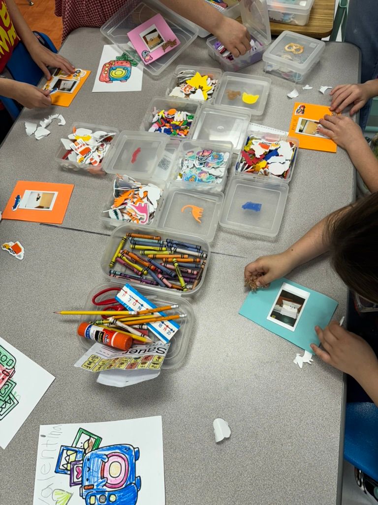 Children doing arts and crafts at a table with bins of crayons, stickers, pencils, and colorful supplies.