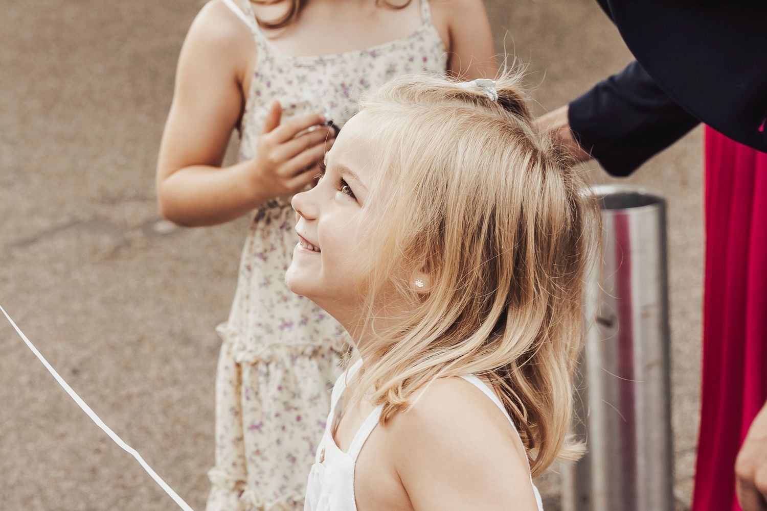 A joyful child laughing outdoors at a celebration.