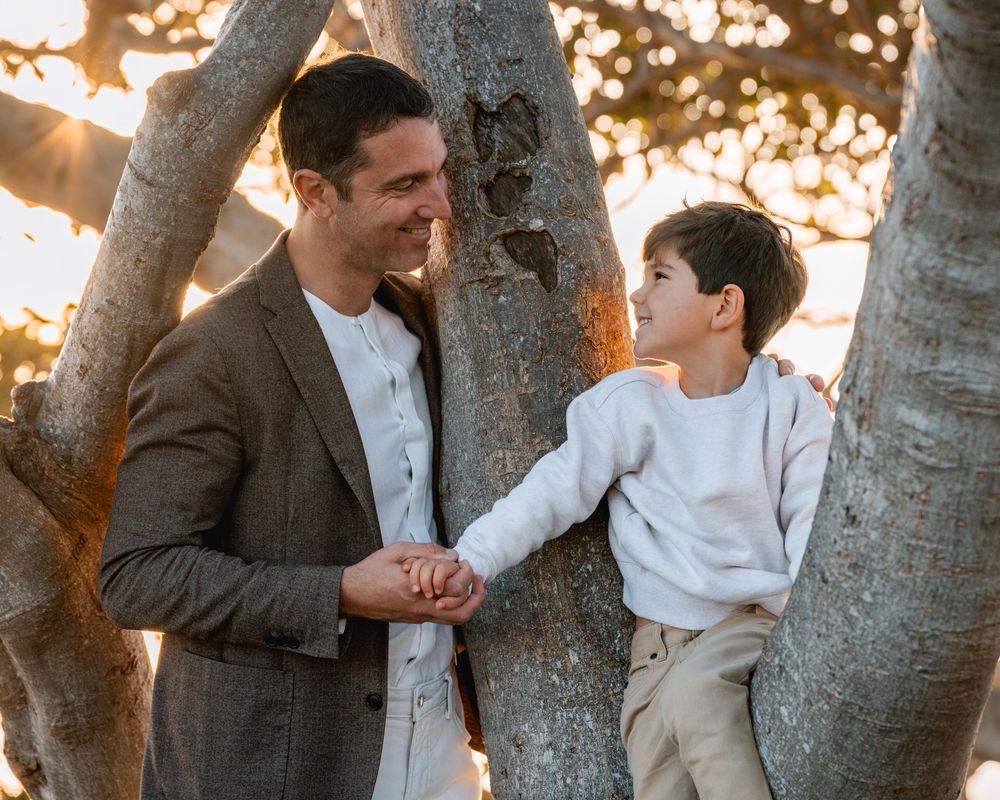 dad-and-son-is-looking-at-each-other-during-a-sunrise-morning-family-photoshoot-in-sydney-balmoral-beach