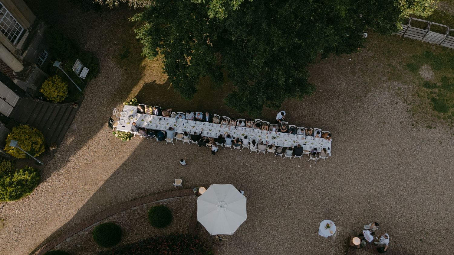 Aerial view of an outdoor wedding venue with garden pathways and guest seating.