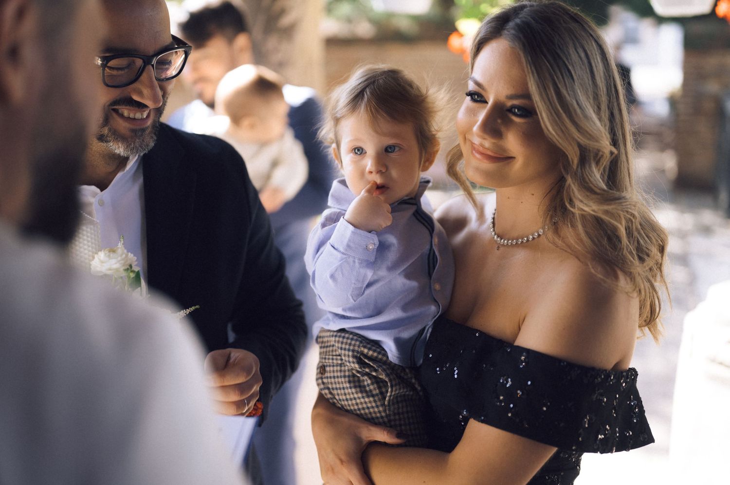 Guests mingle and interact during an indoor wedding reception with rustic wooden interior details.