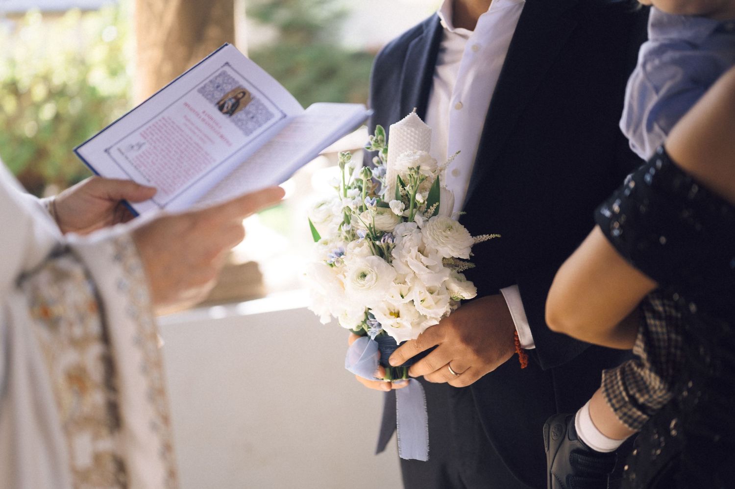 A close-up view of hands holding papers and documents during an outdoor event.