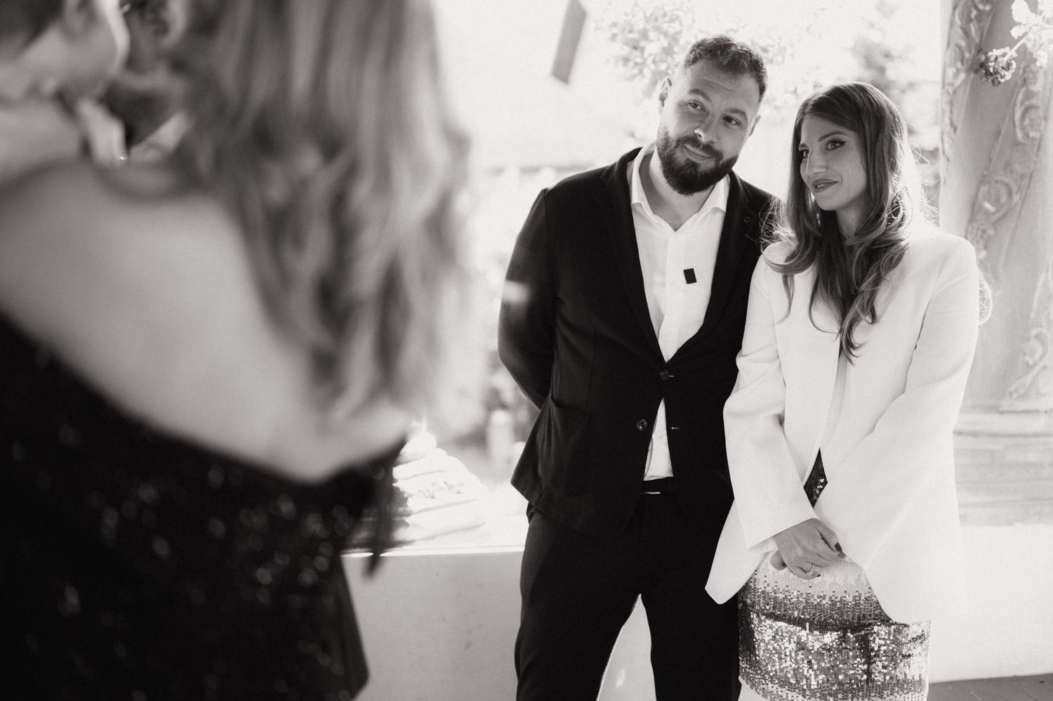 A series of black and white wedding photos showing romantic moments between a couple in formal attire.