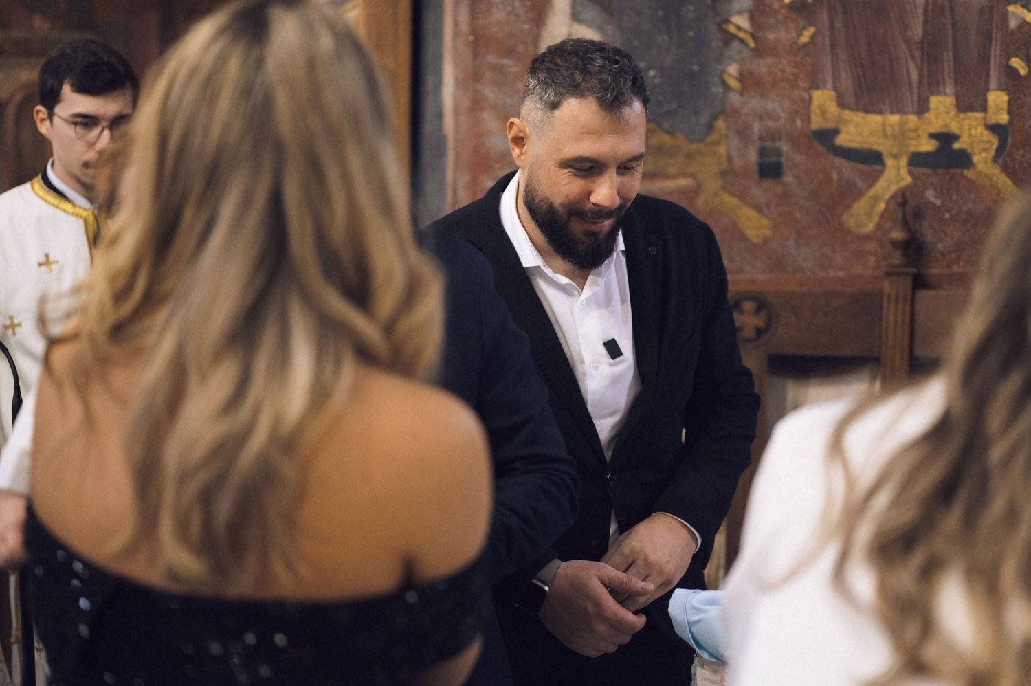 A couple in formal attire sharing an intimate moment at a wedding reception.