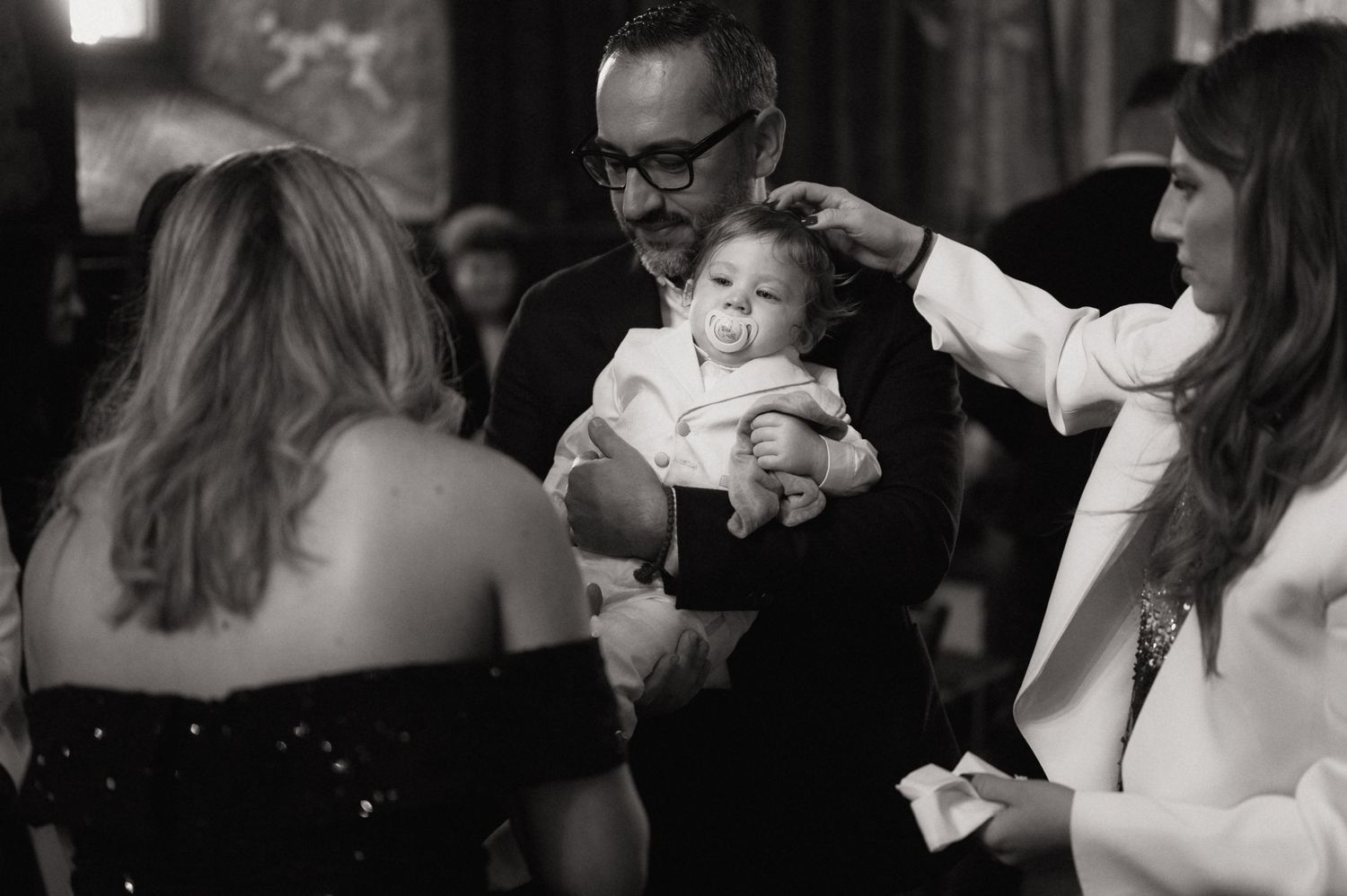 A series of black and white candid photos showing intimate moments at a wedding celebration.