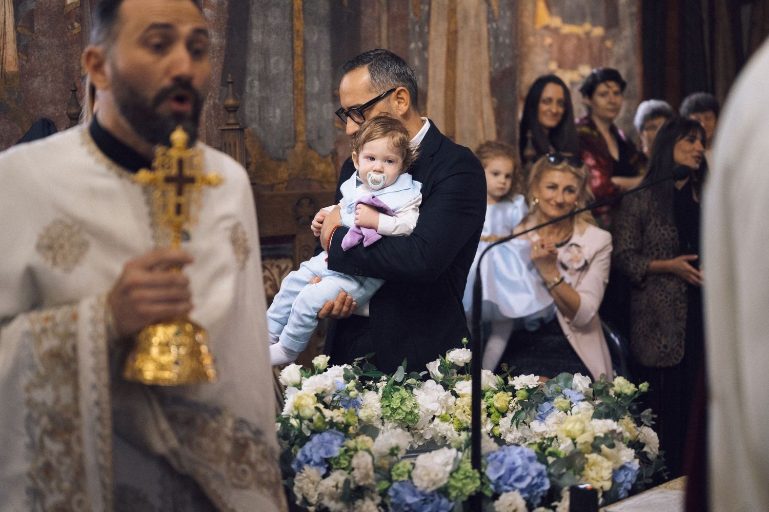 A collection of wedding moments showing floral arrangements with blue and white flowers, and guests at an elegant venue.