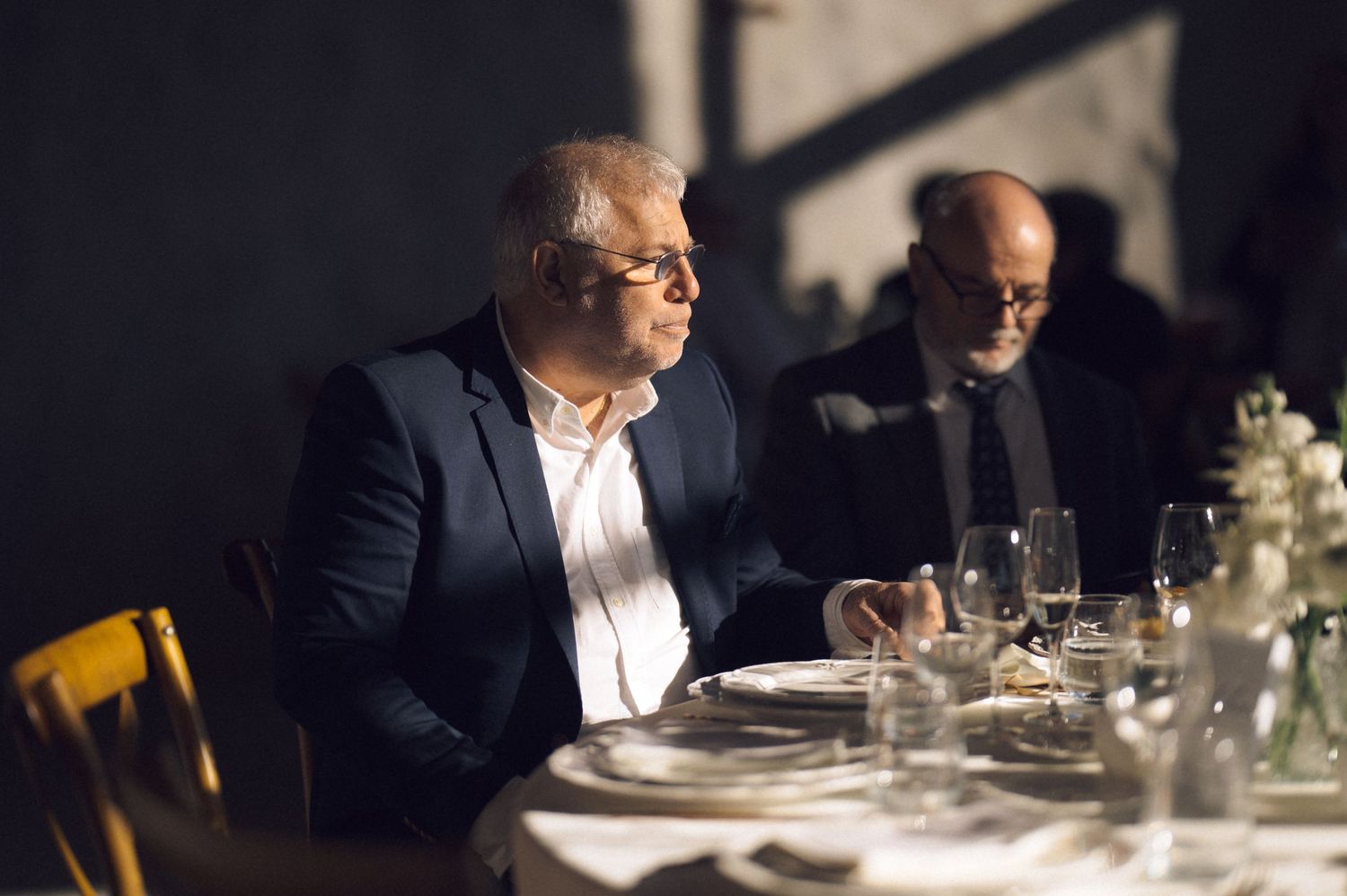 People enjoying a fine dining experience in an elegant restaurant setting with ambient lighting and table settings.