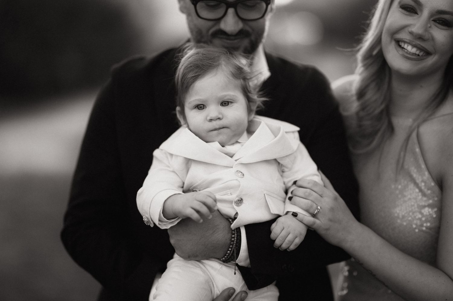 A series of black and white photos showing joyful moments at a wedding celebration.