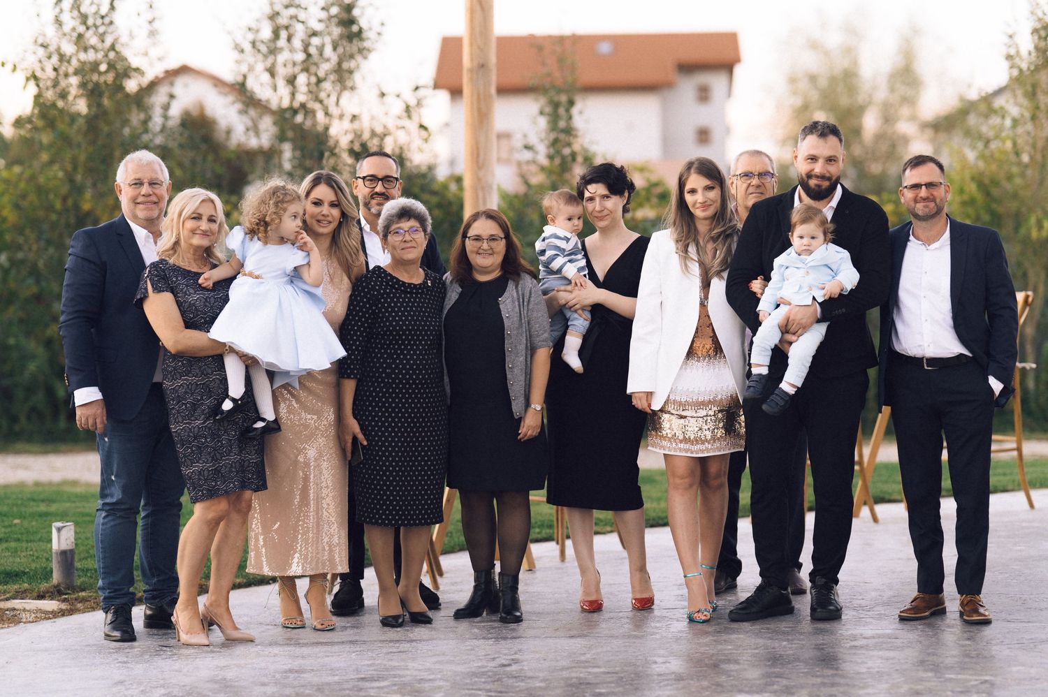 A creative panoramic wedding party photo shows legs and feet of multiple people standing in a row outdoors.
